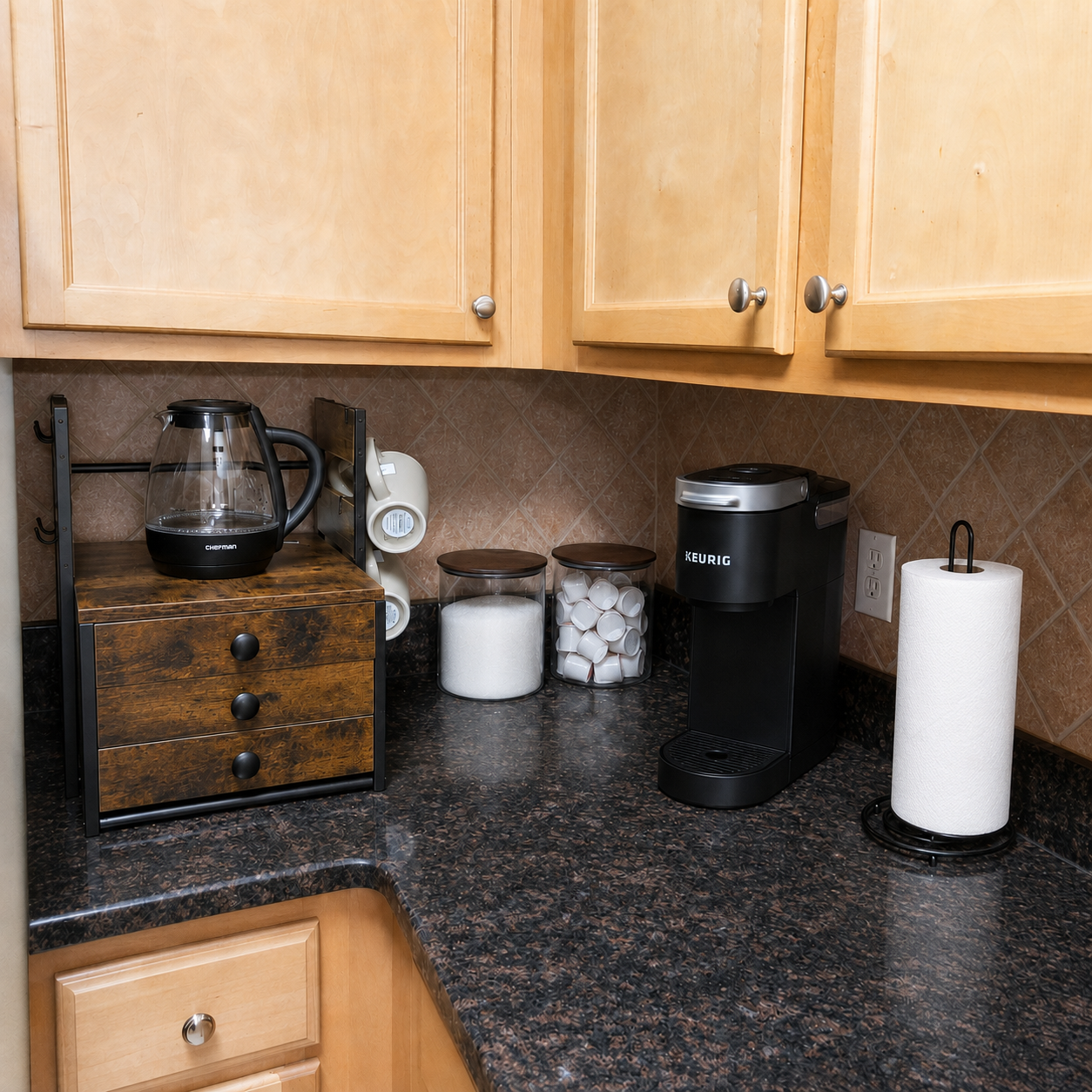 Stocked coffee station with Keurig, kettle, sugar, creamers, and paper towels