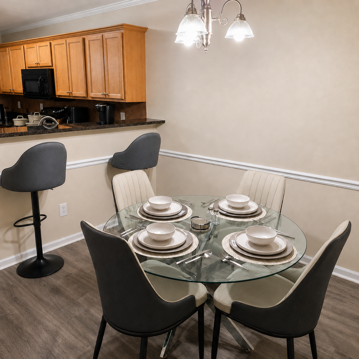 Dining table set for four beside the fully equipped kitchen
